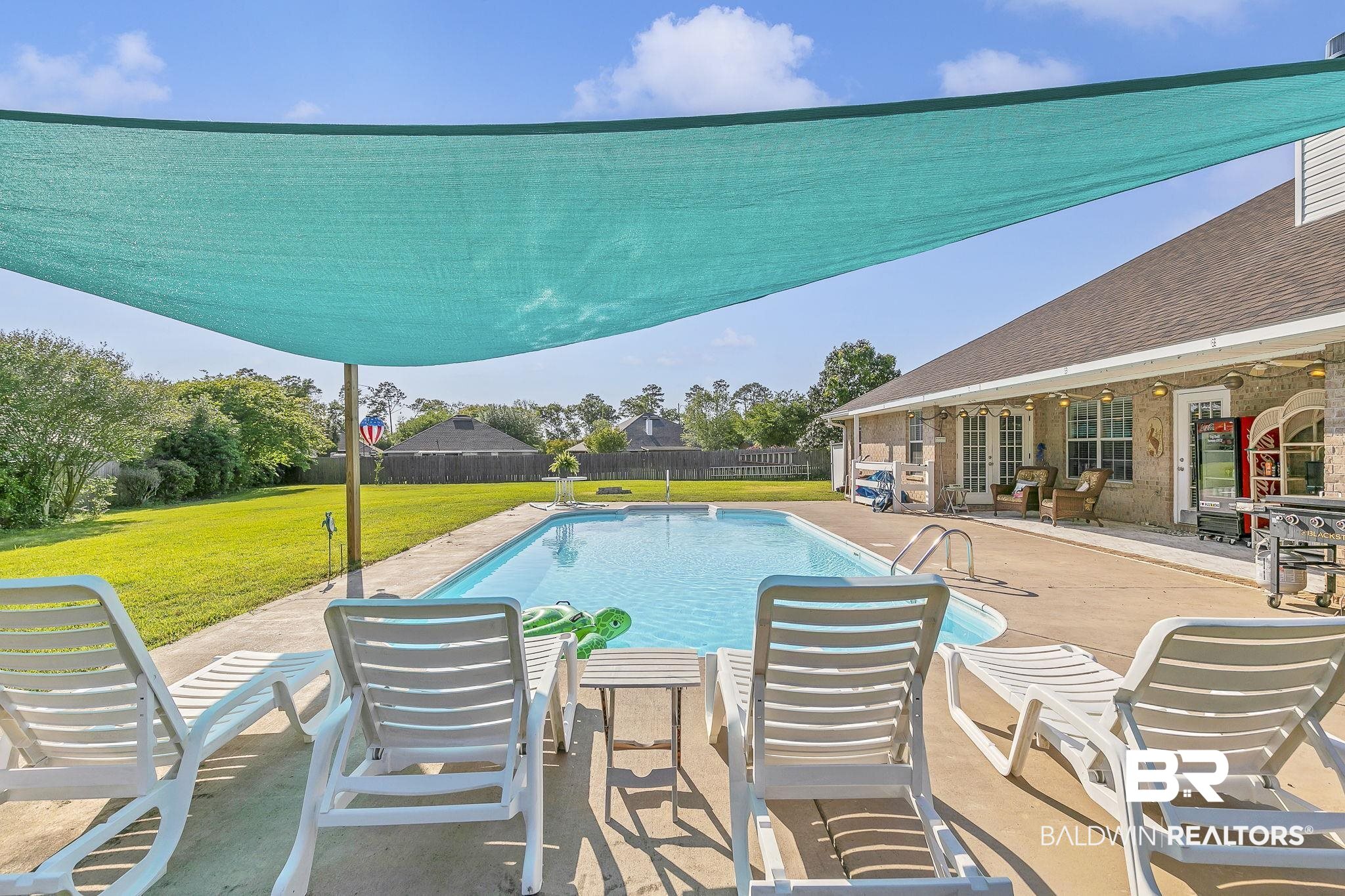 16358 Tempest Drive Foley, AL 36535 - Photo 36 of 46 View of pool featuring a lawn, fence, a patio area, and a fenced in pool