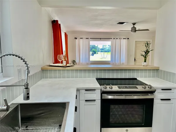a kitchen with stainless steel appliances granite countertop a stove and a microwave