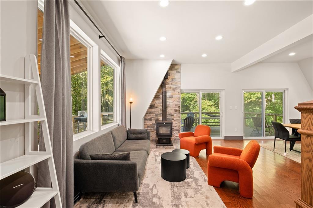 146 Luna Way Markleton, PA 15551 - Photo 12 of 50 a living room with furniture a fireplace and large windows