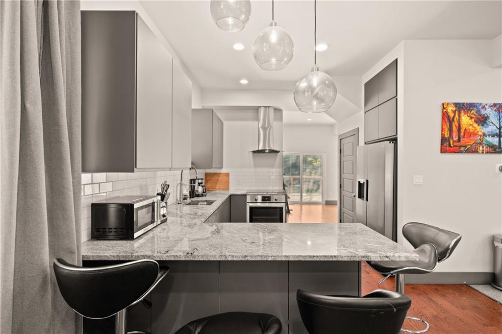 146 Luna Way Markleton, PA 15551 - Photo 16 of 50 a kitchen with stainless steel appliances granite countertop a kitchen island hardwood floor and a sink