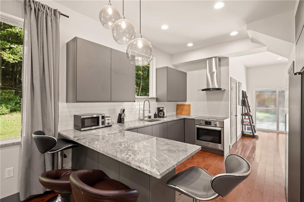 146 Luna Way Markleton, PA 15551 - Photo 17 of 50 a kitchen with kitchen island granite countertop a sink a counter top space appliances and cabinets