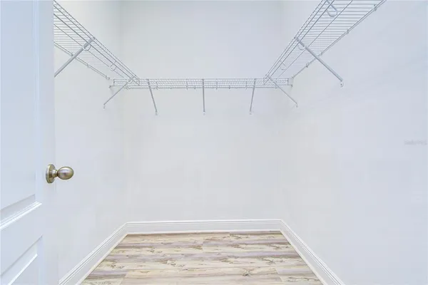 a spacious bathroom with a mirror a shower and vanity