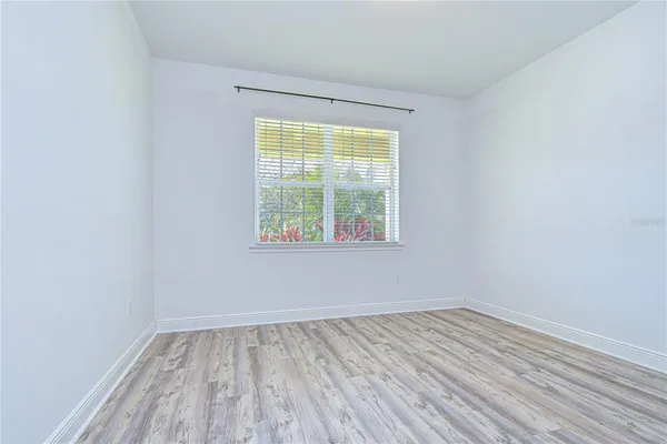 a view of an empty room and wooden floor