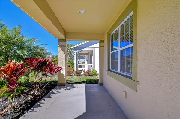 a view of house with a porch and furniture