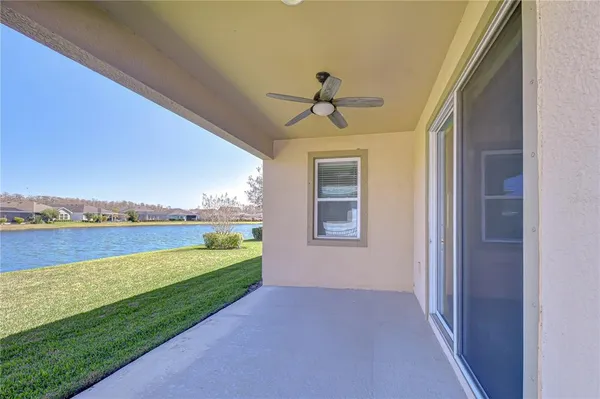 a view of a house with a yard and a fountain