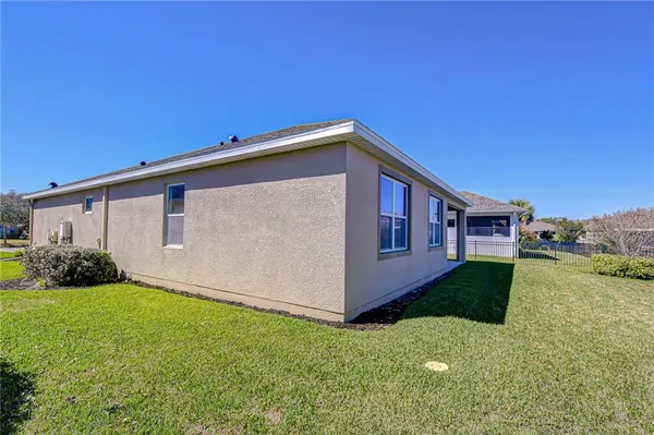 a view of house with a yard