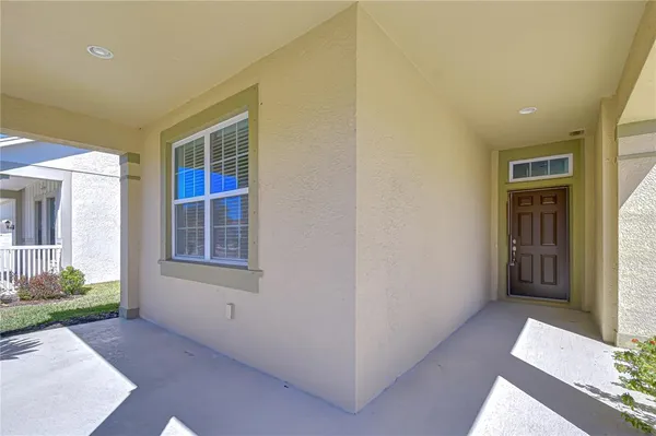 an empty room with a window and wooden floor