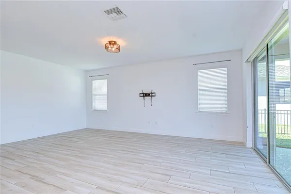 a view of kitchen with kitchen island stainless steel appliances wooden floor and window