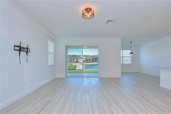 a kitchen with kitchen island a counter space a refrigerator and a sink
