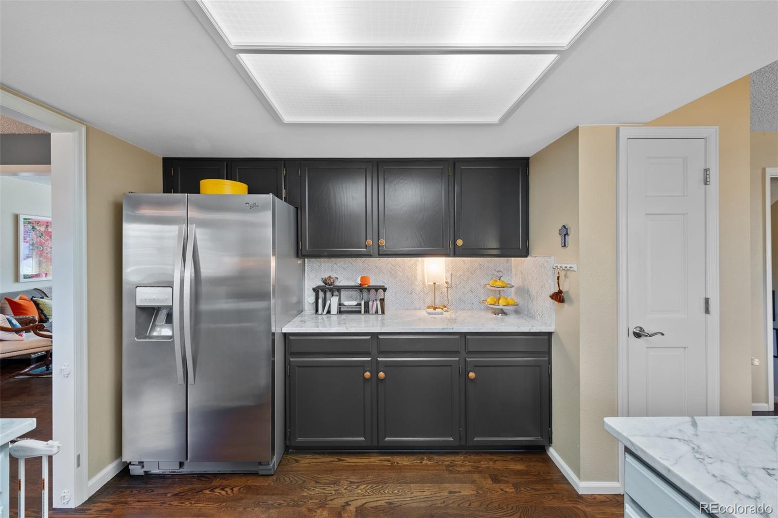 145 Willowleaf Drive Littleton, CO 80127 - Photo 13 of 42 a kitchen with stainless steel appliances granite countertop a refrigerator and a sink