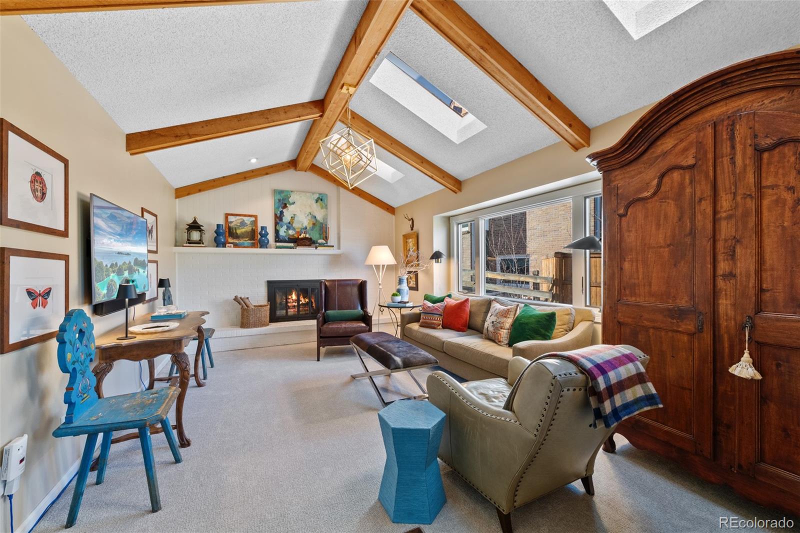 145 Willowleaf Drive Littleton, CO 80127 - Photo 15 of 42 a living room with furniture a fireplace and a large window