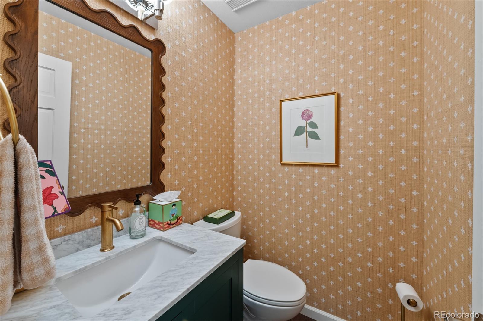 145 Willowleaf Drive Littleton, CO 80127 - Photo 18 of 42 a bathroom with a granite countertop sink mirror vanity and toilet