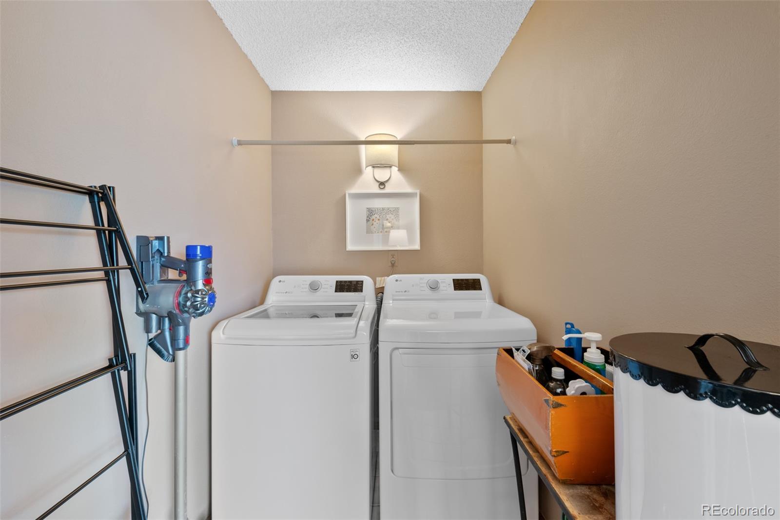 145 Willowleaf Drive Littleton, CO 80127 - Photo 19 of 42 a utility room with dryer and washer