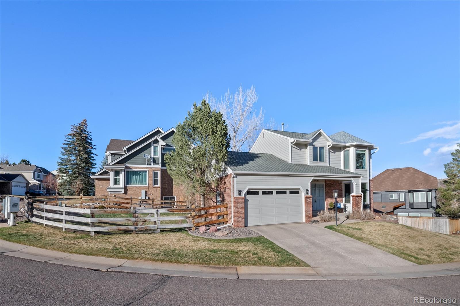 145 Willowleaf Drive Littleton, CO 80127 - Photo 2 of 42 a front view of a house with a garden
