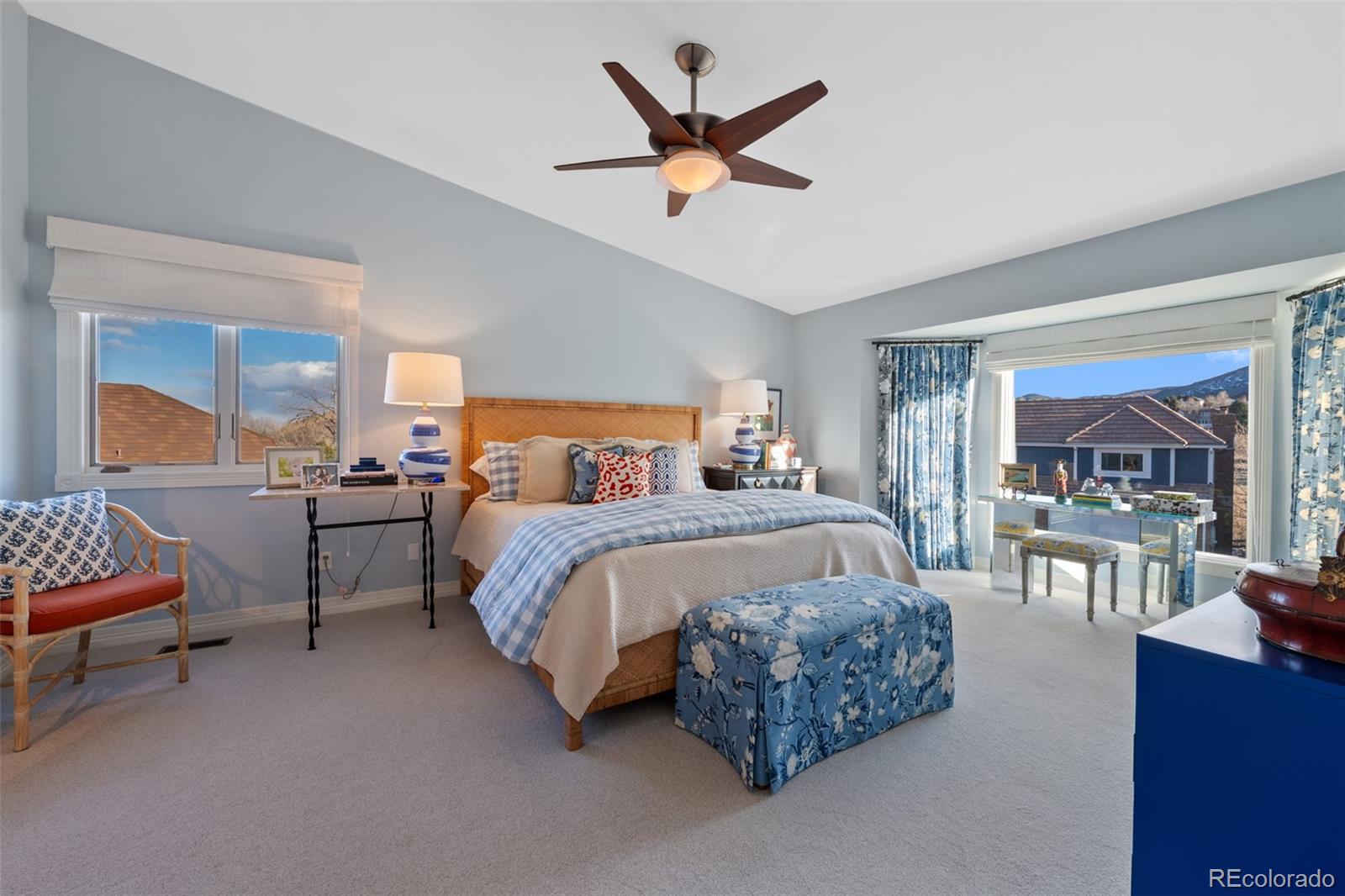 145 Willowleaf Drive Littleton, CO 80127 - Photo 21 of 42 a bedroom with a bed a chandelier and a couch