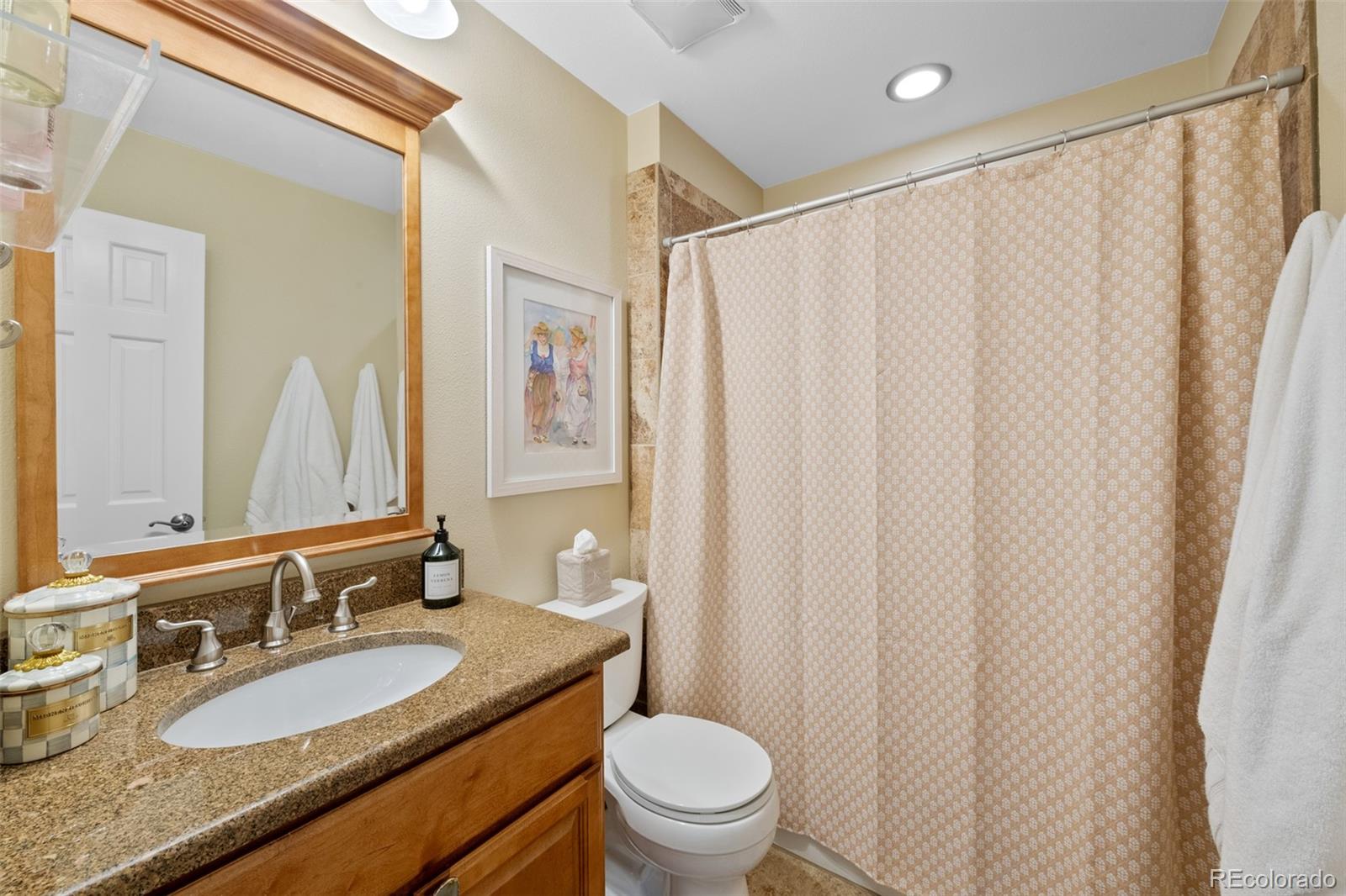 145 Willowleaf Drive Littleton, CO 80127 - Photo 28 of 42 a bathroom with a granite countertop sink toilet and a mirror