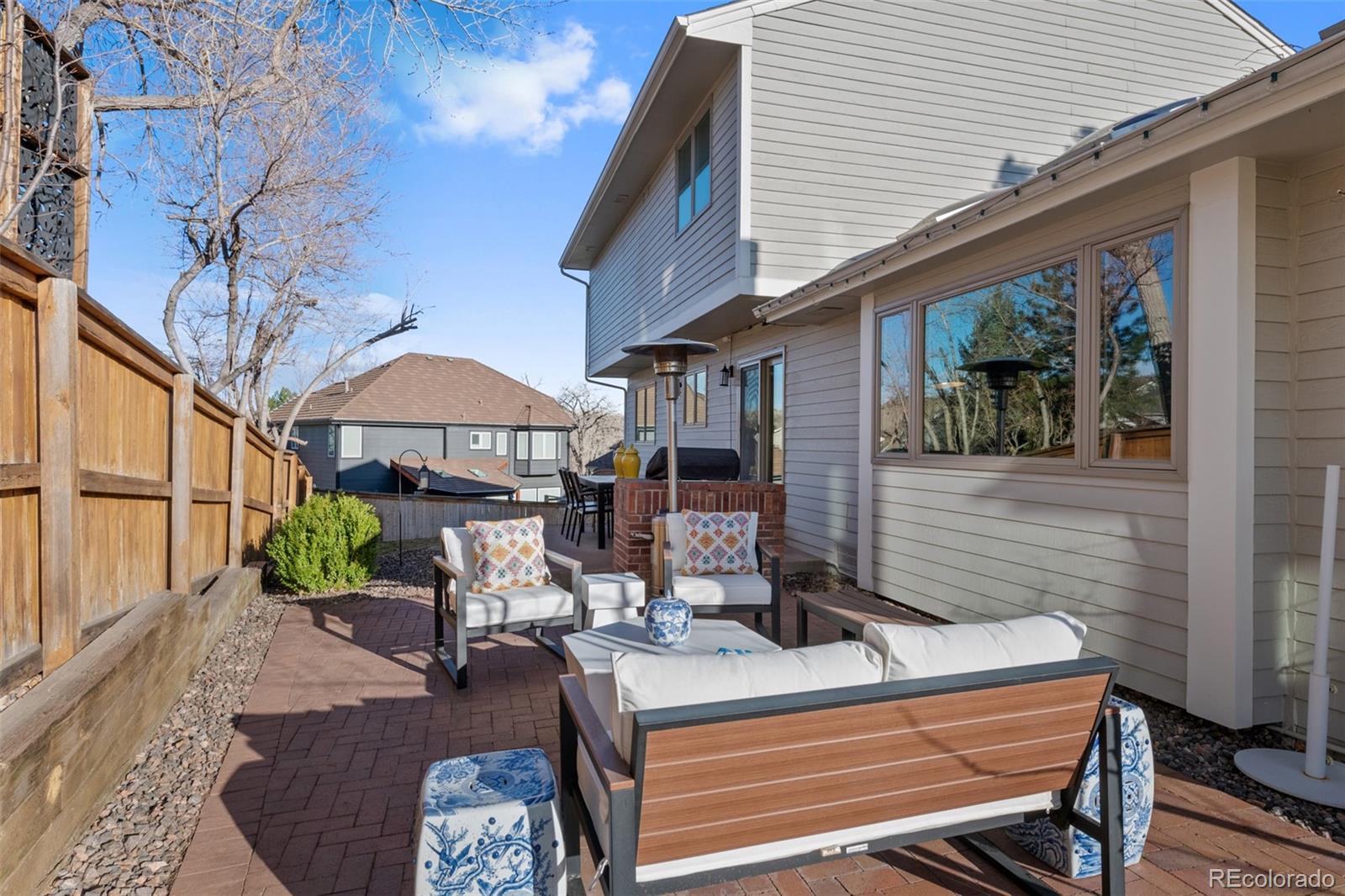 145 Willowleaf Drive Littleton, CO 80127 - Photo 37 of 42 a table and chairs sitting in front of a house