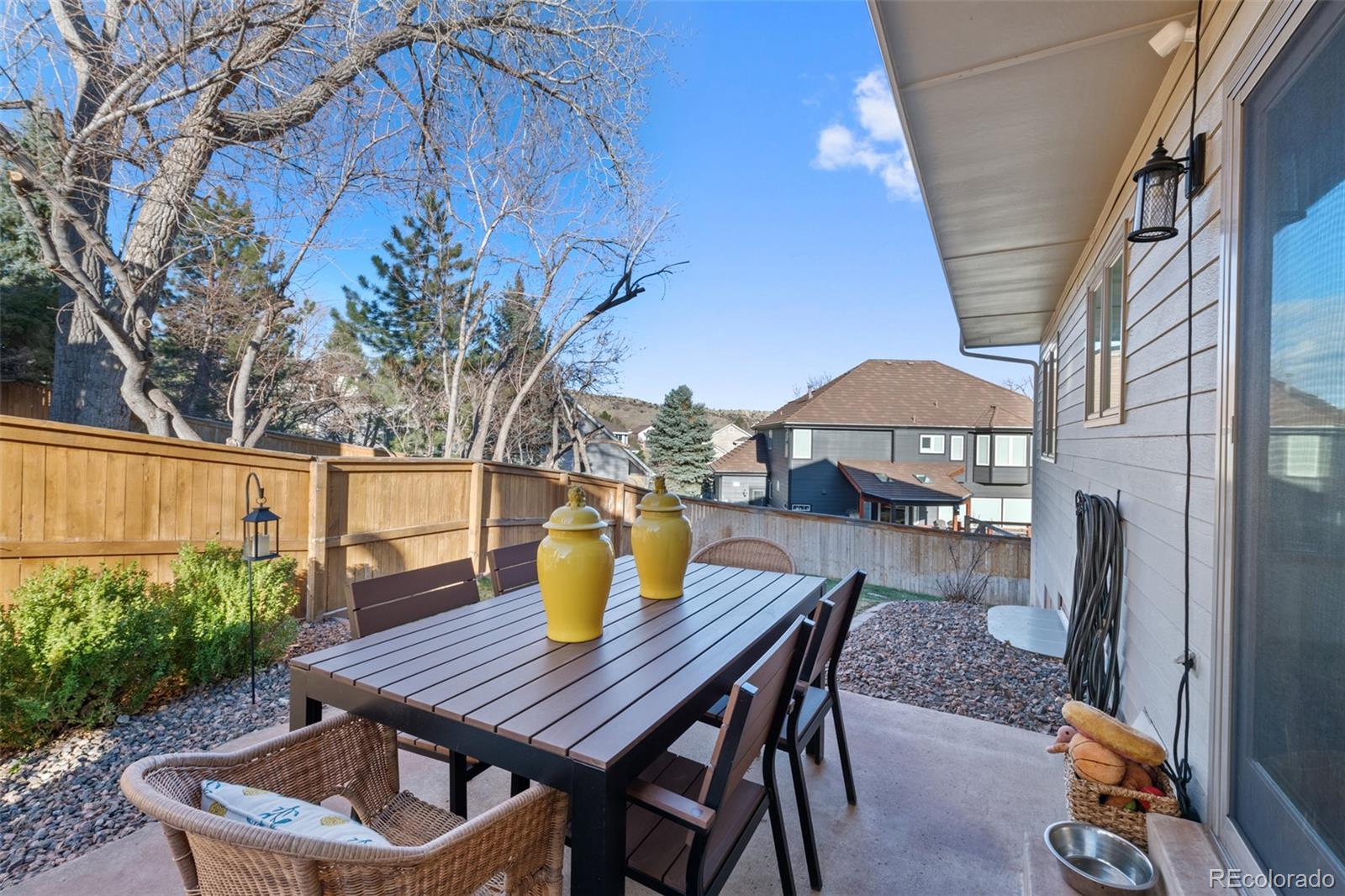 145 Willowleaf Drive Littleton, CO 80127 - Photo 40 of 42 a view of a patio with table and chairs and potted plants