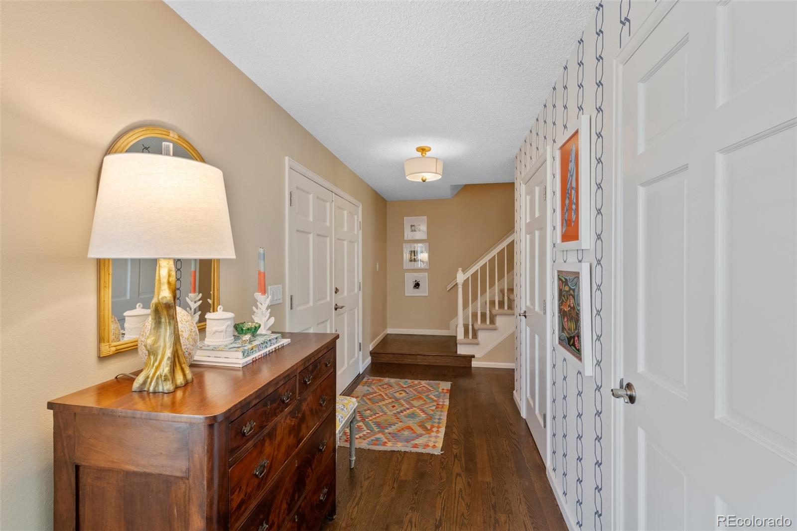 145 Willowleaf Drive Littleton, CO 80127 - Photo 4 of 42 a living room with furniture and a wooden floor