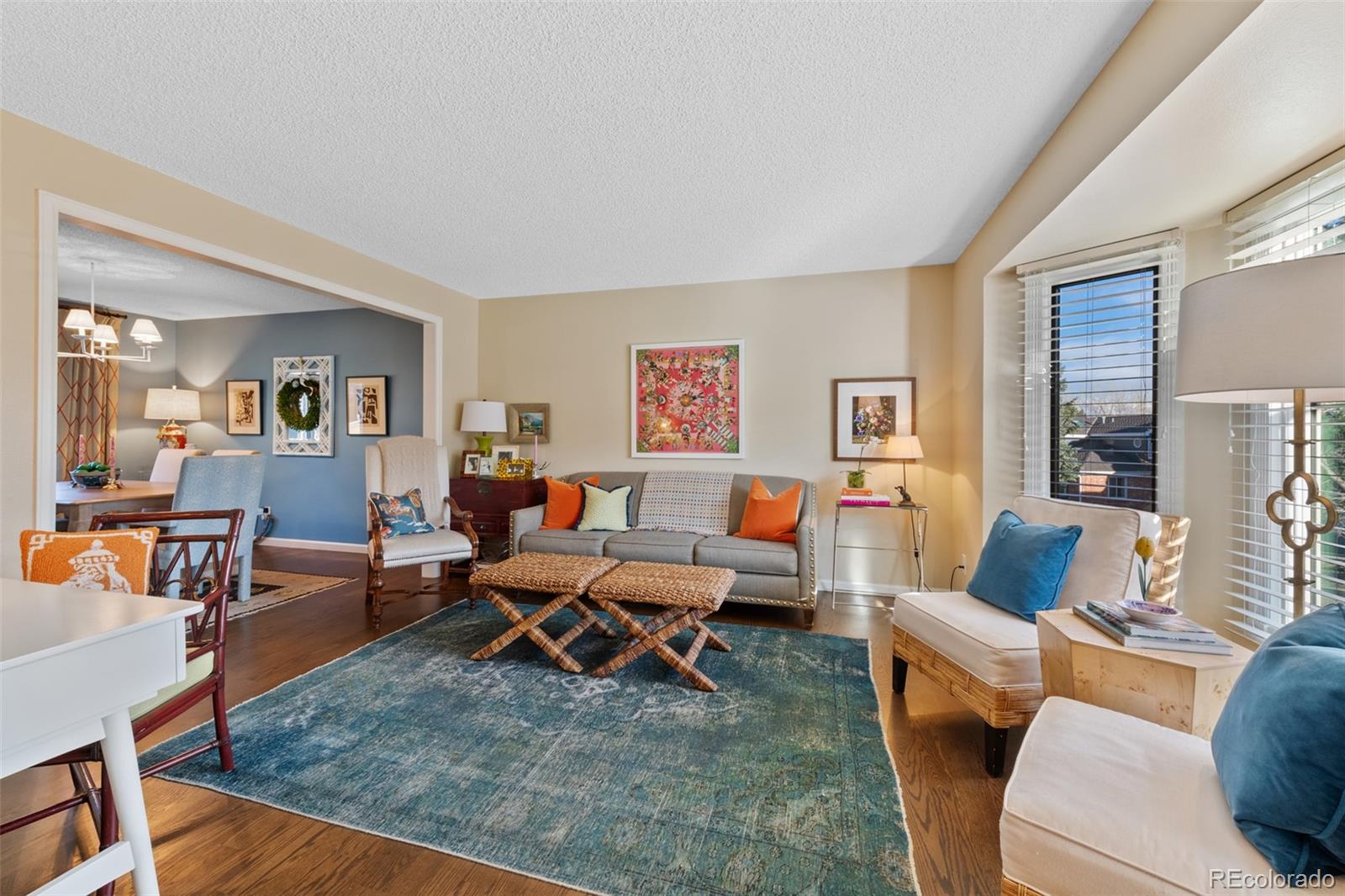 145 Willowleaf Drive Littleton, CO 80127 - Photo 6 of 42 a living room with furniture wooden floor and a table