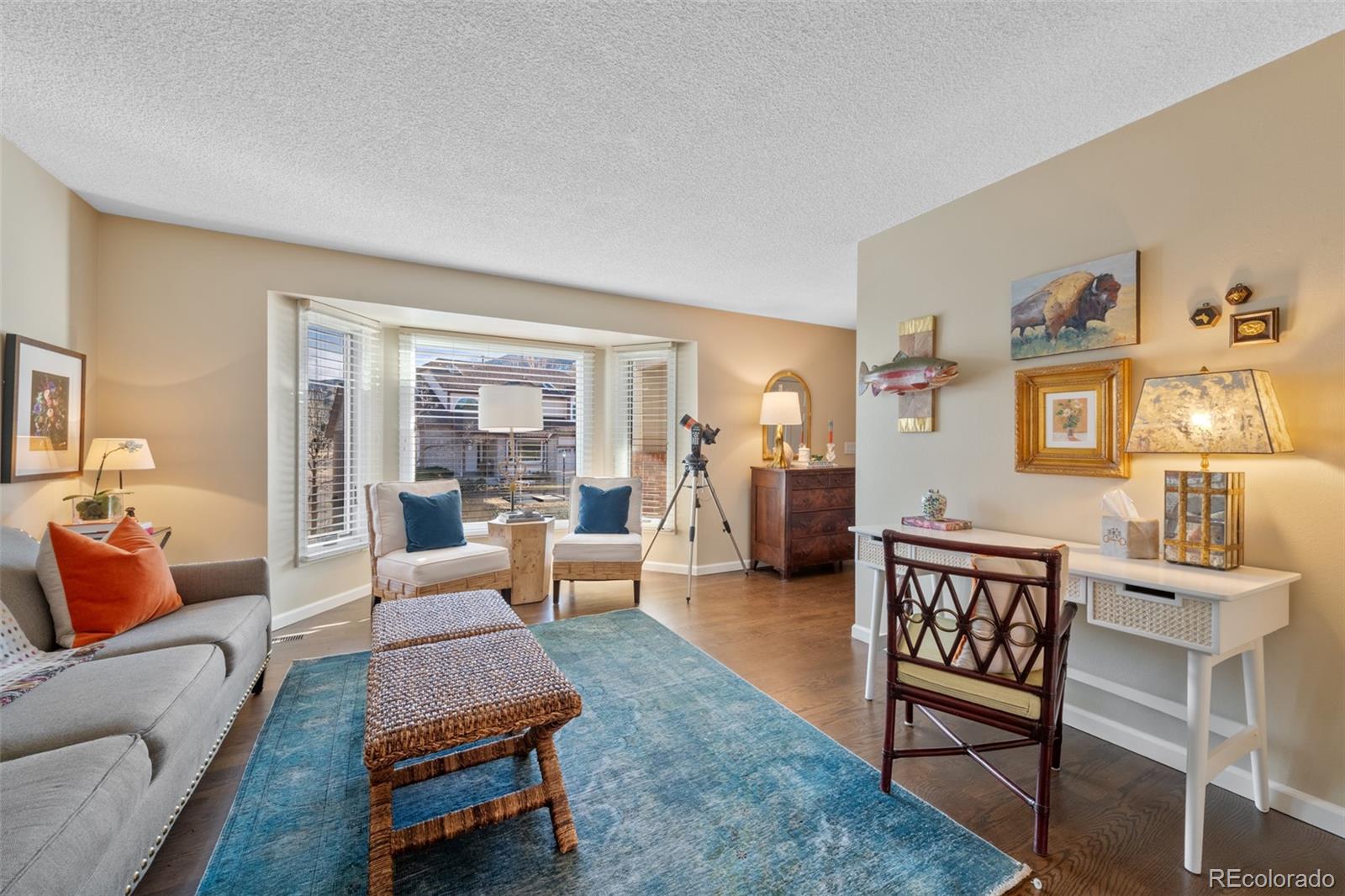 145 Willowleaf Drive Littleton, CO 80127 - Photo 7 of 42 a living room with furniture and wooden floor