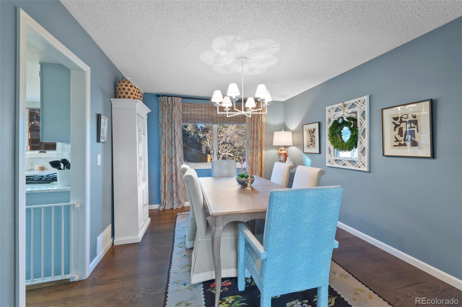 145 Willowleaf Drive Littleton, CO 80127 - Photo 10 of 42 a view of a dining room with furniture and chandelier