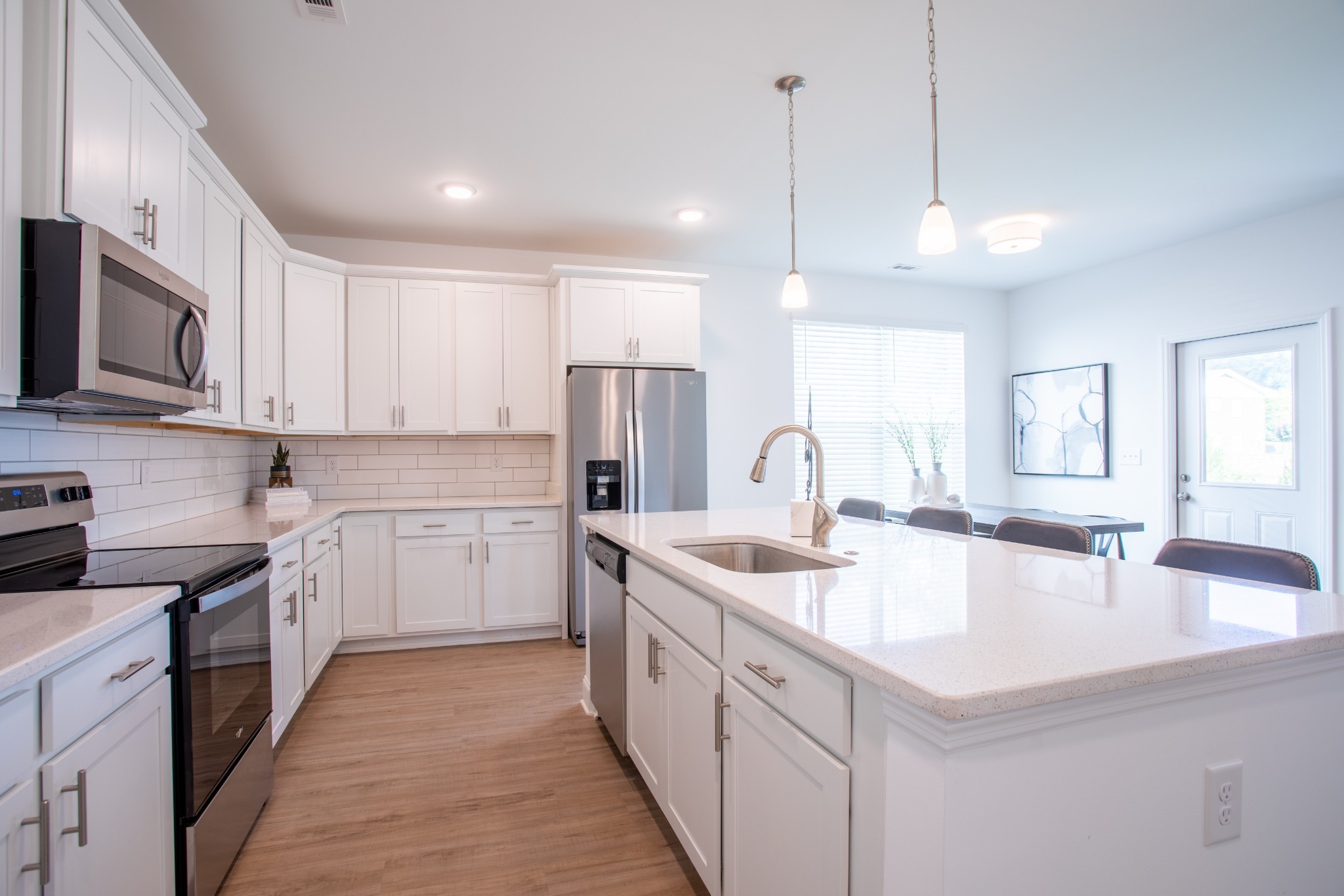 4918 Dyno Loop Chattanooga, TN 37415 - Photo 3 of 17 a kitchen with stainless steel appliances granite countertop a sink a stove and a wooden floors