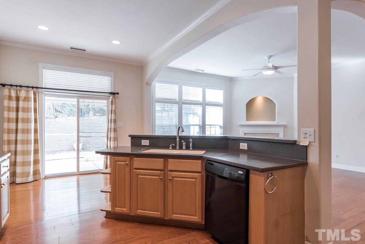 12227 Orchardgrass Lane Raleigh, NC 27614 - Photo 11 of 25 a kitchen with stainless steel appliances granite countertop a sink a stove cabinets and wooden floor