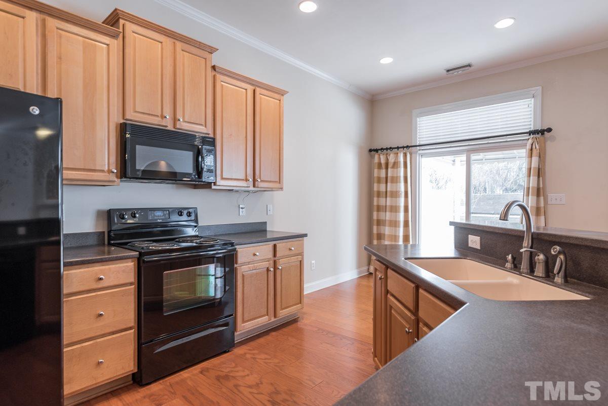 12227 Orchardgrass Lane Raleigh, NC 27614 - Photo 12 of 25 a kitchen with stainless steel appliances granite countertop a stove a sink and a microwave