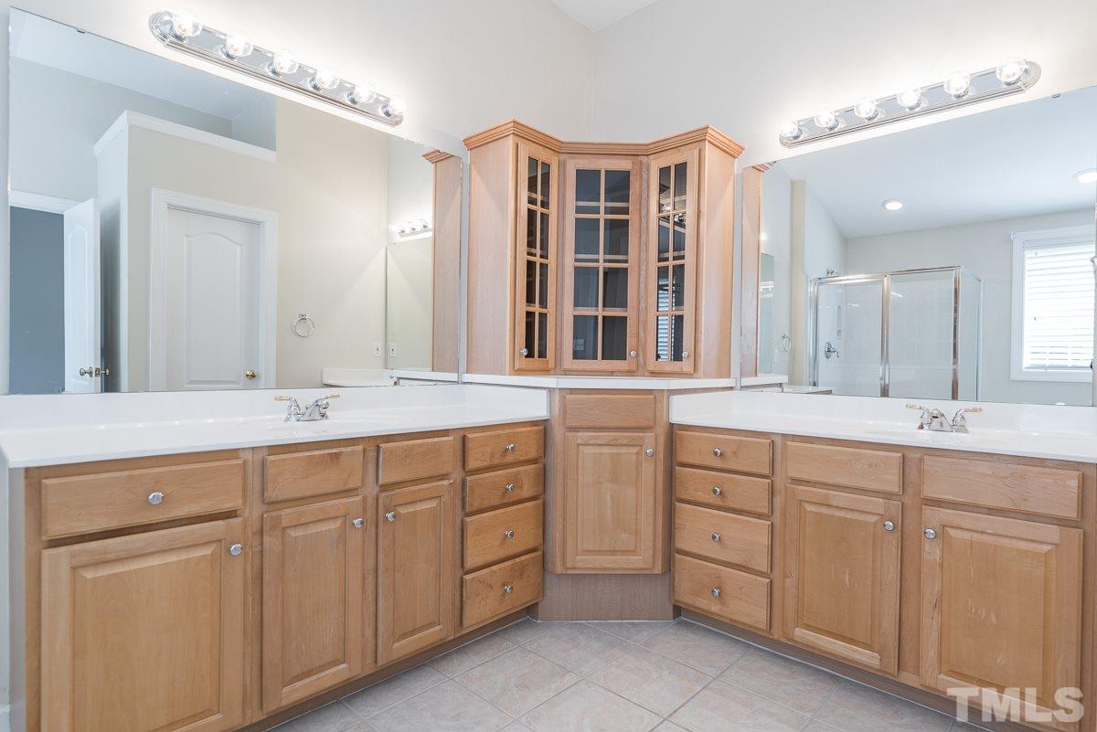 12227 Orchardgrass Lane Raleigh, NC 27614 - Photo 18 of 25 a spacious bathroom with double sink and a large mirror