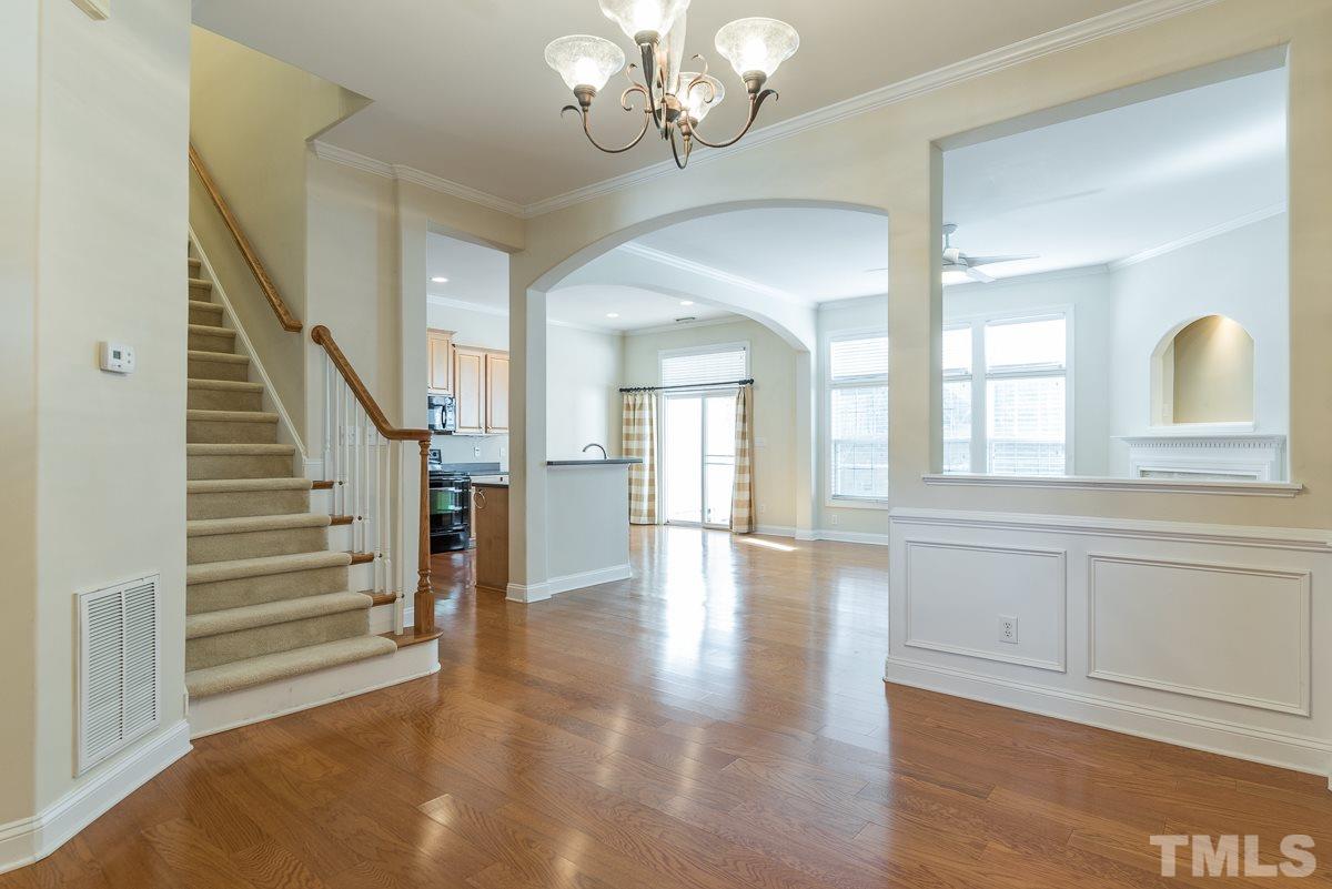 12227 Orchardgrass Lane Raleigh, NC 27614 - Photo 5 of 25 a view of a hallway with entryway wooden floor and front door
