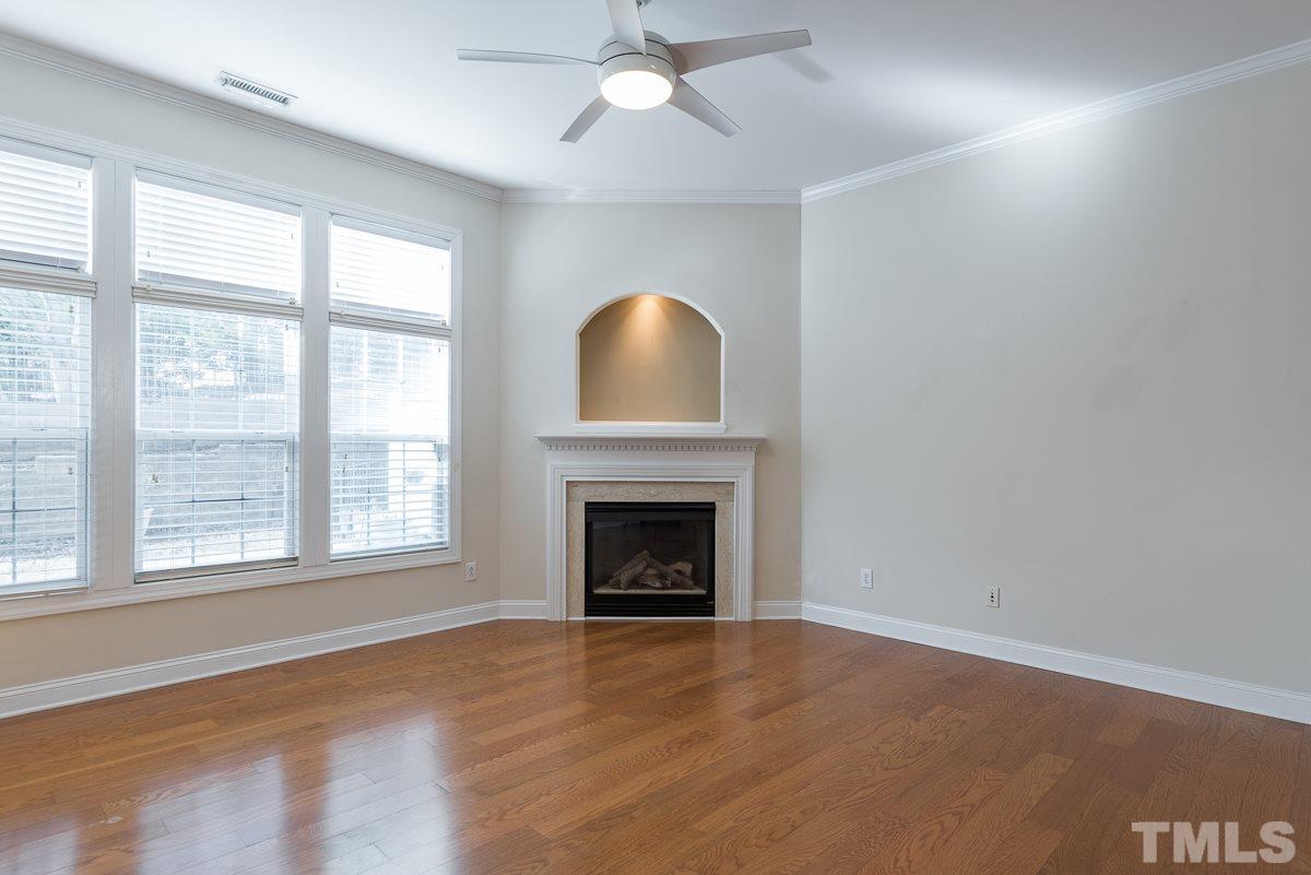 12227 Orchardgrass Lane Raleigh, NC 27614 - Photo 6 of 25 an empty room with chandelier fan and windows