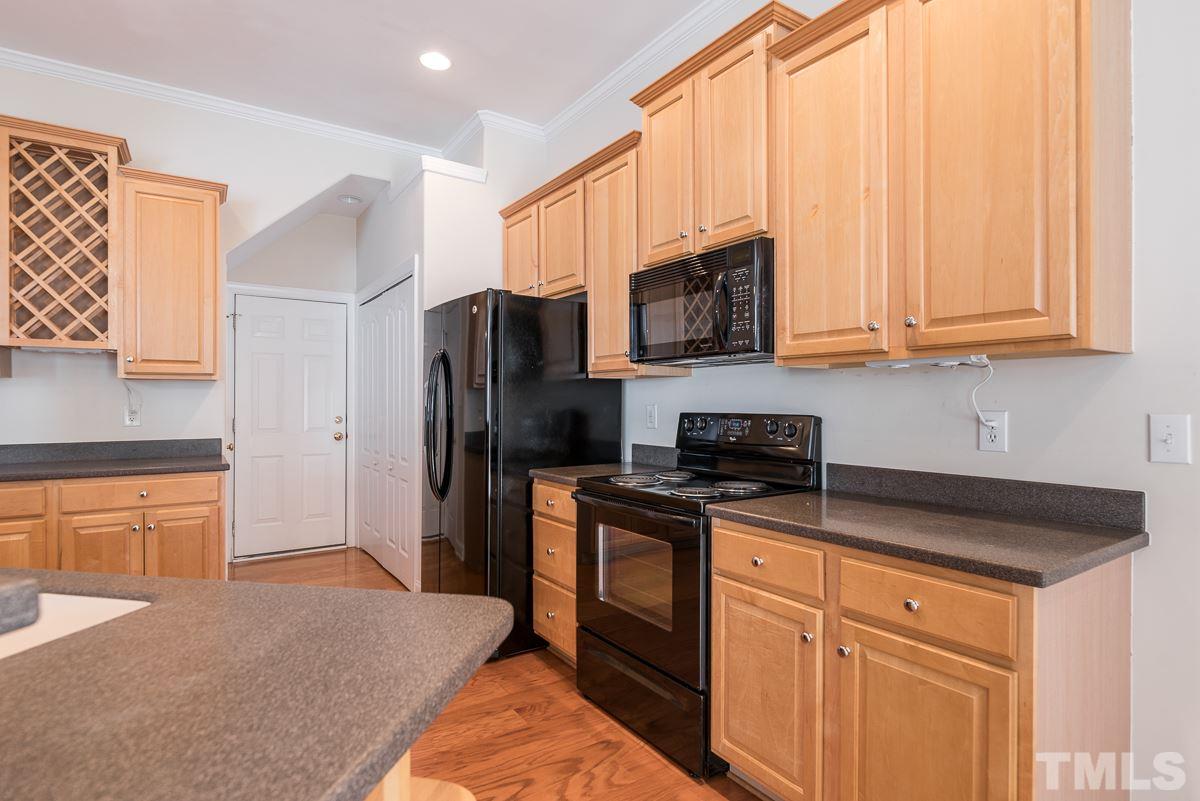 12227 Orchardgrass Lane Raleigh, NC 27614 - Photo 10 of 25 a kitchen with stainless steel appliances granite countertop a refrigerator stove microwave and sink