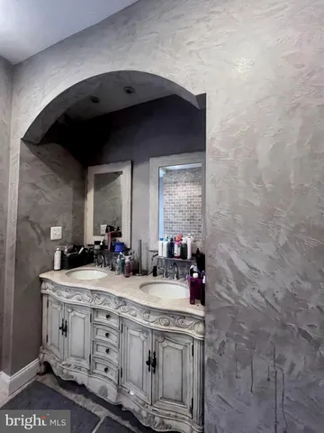 a bathroom with a bathtub and a sink