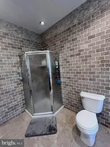 a bedroom with a bed and a television