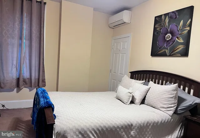 a bed room with furniture and a chair