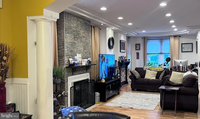 a living room with lots of furniture and a wooden floor