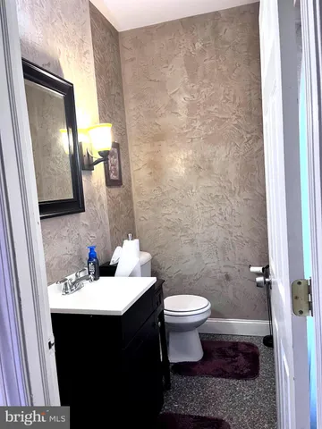 a living room with dining table furniture and a chandelier