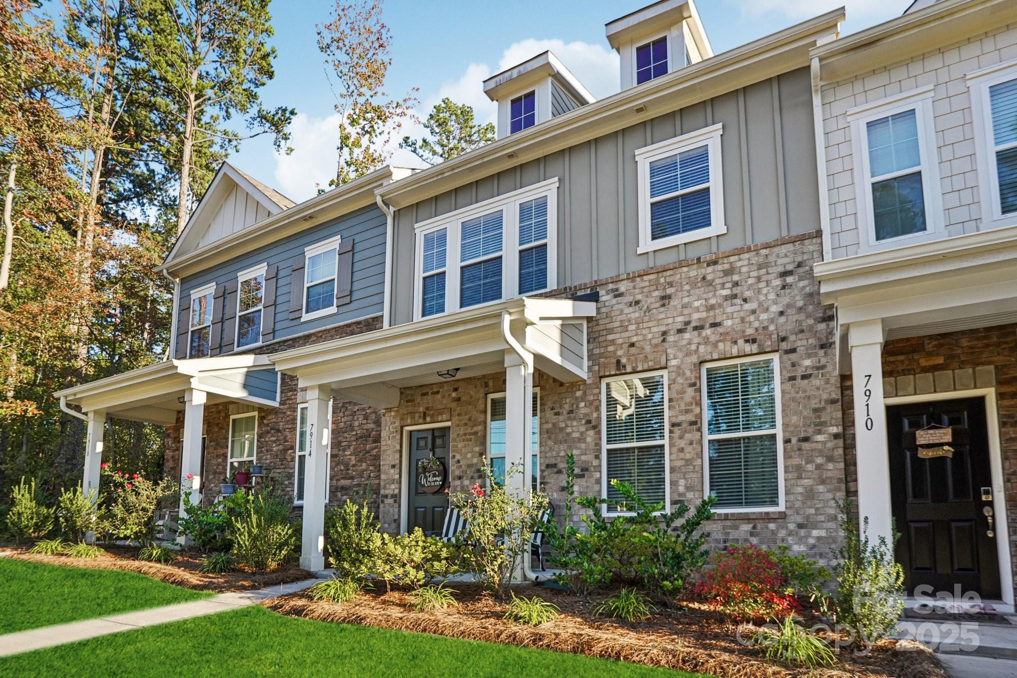 front view of a brick house with a yard
