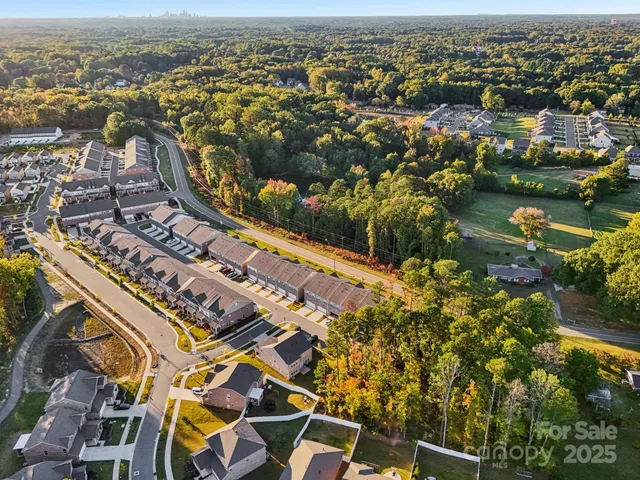 an aerial view of residential building and lake