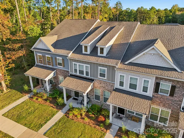 a aerial view of a house with swimming pool and sitting area