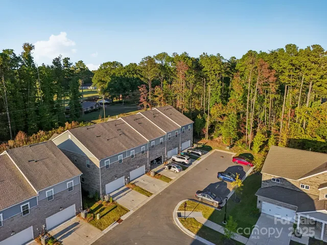 an aerial view of a house with a big yard