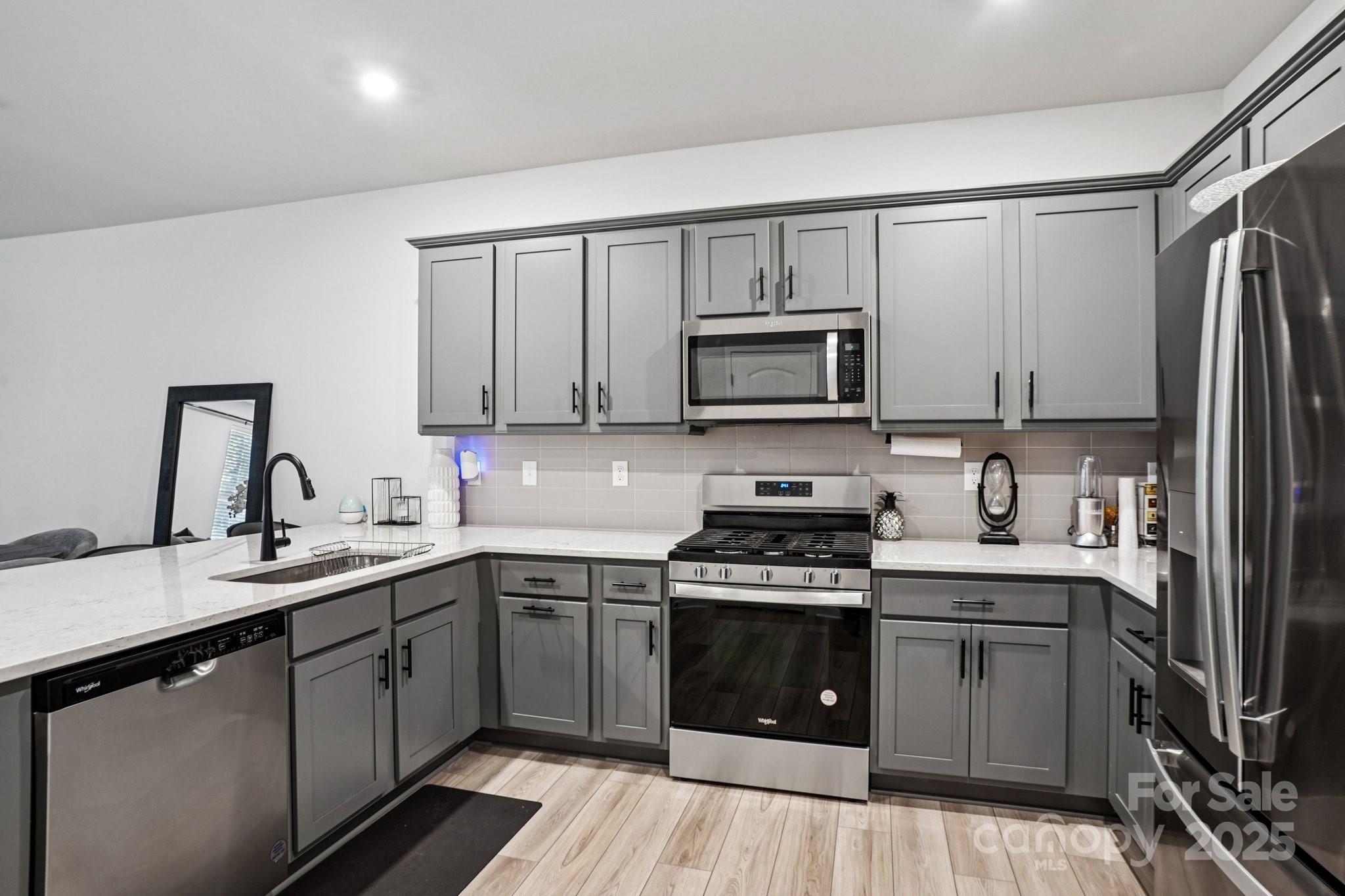 7914 Nelson Road Mint Hill, NC 28227 - Photo 8 of 25 a kitchen with stainless steel appliances a sink cabinets and a stove top oven