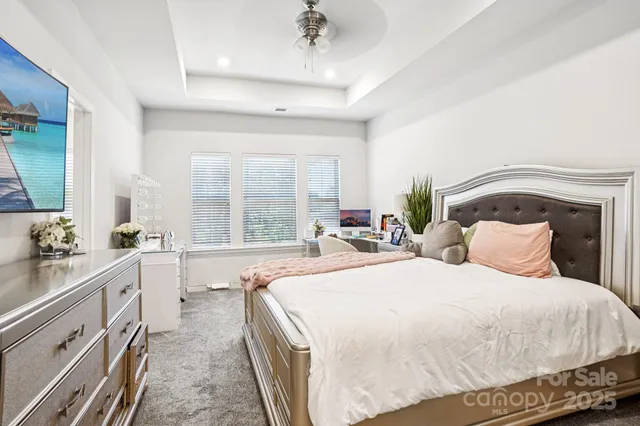 a spacious bedroom with a bed and a large window