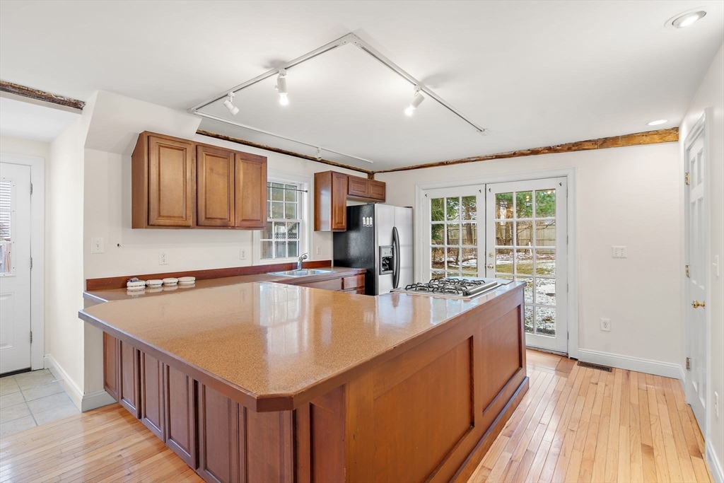 35 Water Street, Unit 35 Concord, MA 01742 - Photo 1 of 20 a large kitchen with kitchen island a large counter space a sink appliances and cabinets