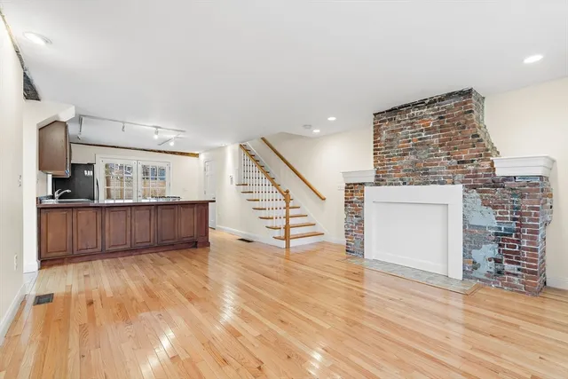 a view of kitchen with furniture and wooden floor