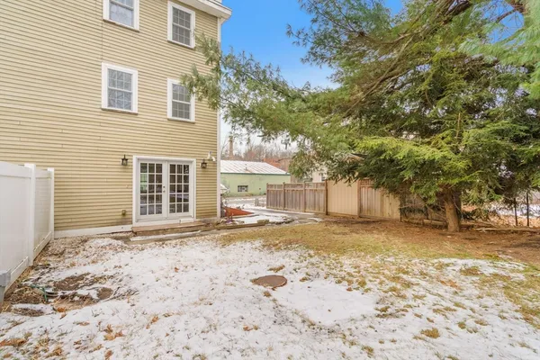 a view of a yard with a house in the background