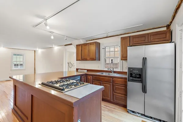 a kitchen with stainless steel appliances granite countertop a stove a refrigerator and a sink