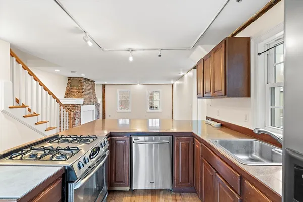 a kitchen with stainless steel appliances granite countertop a stove and a sink