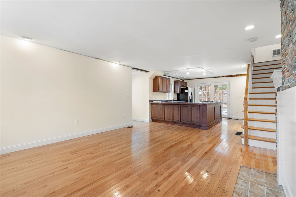 35 Water Street, Unit 35 Concord, MA 01742 - Photo 8 of 20 a view of a kitchen with wooden floor and stairs
